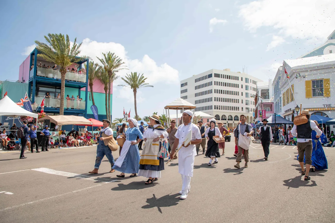 A group of people are walking in the Bermuda Day parade.