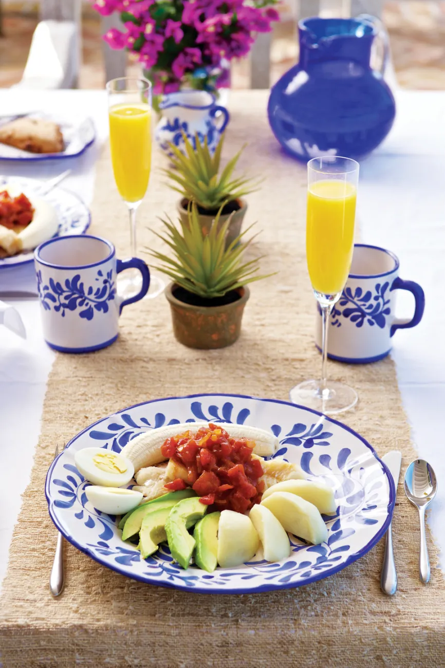 A traditional codfish breakfast with mimosas and colourful plate.