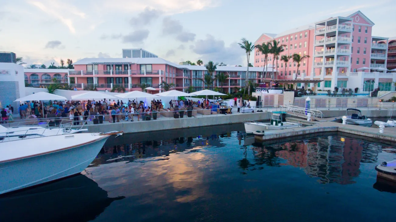 A group of people are standing outside of a bar.