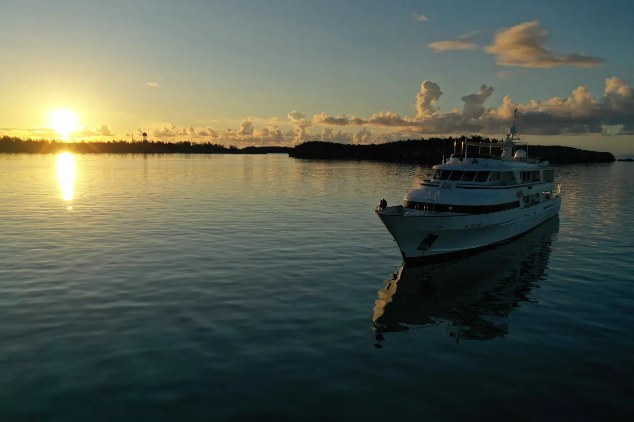 Drone view of a boat at sunset.