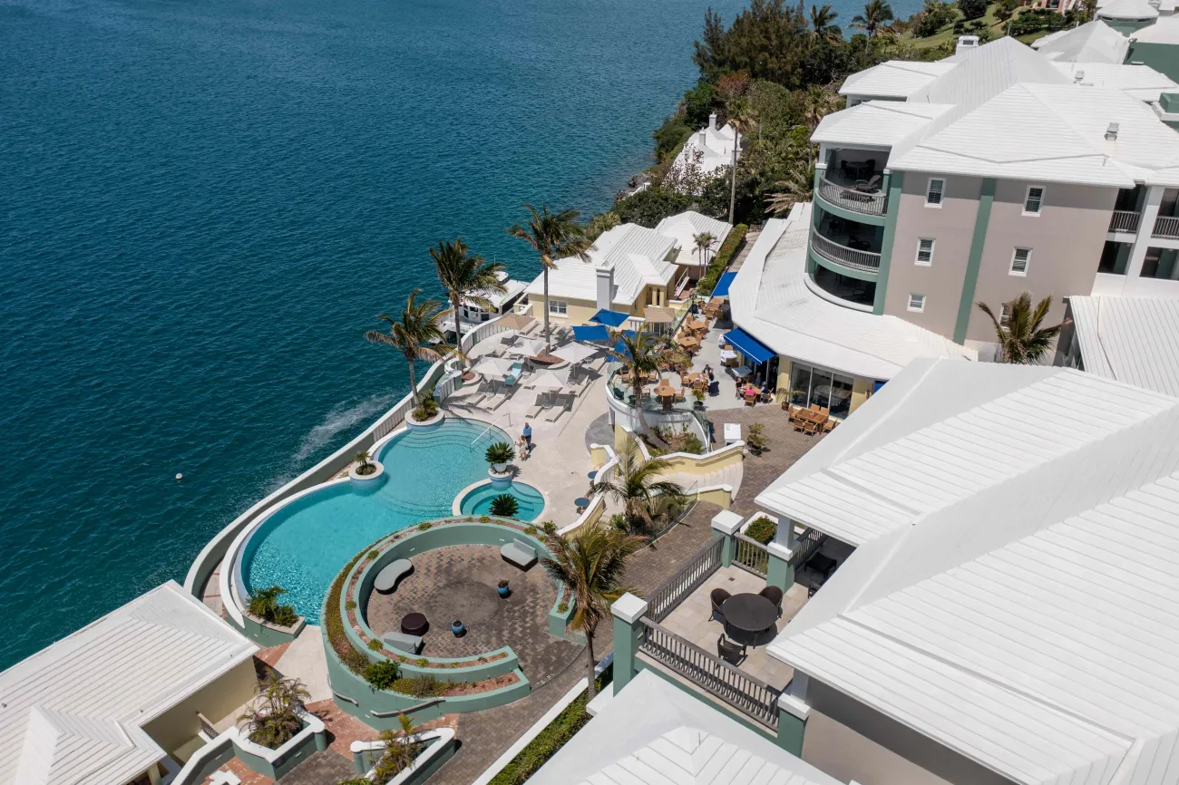 Aerial view of Newstead Belmont hotel with a lush greenery and a pool.