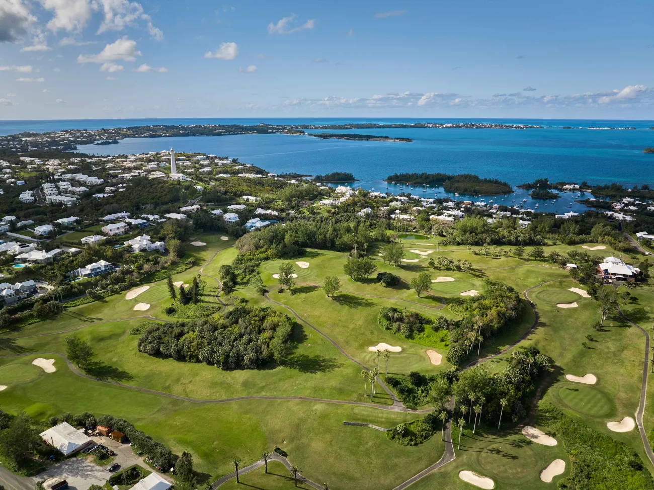 Aerial view of Turtle Hill Golf Course with blue skies and green fairways.