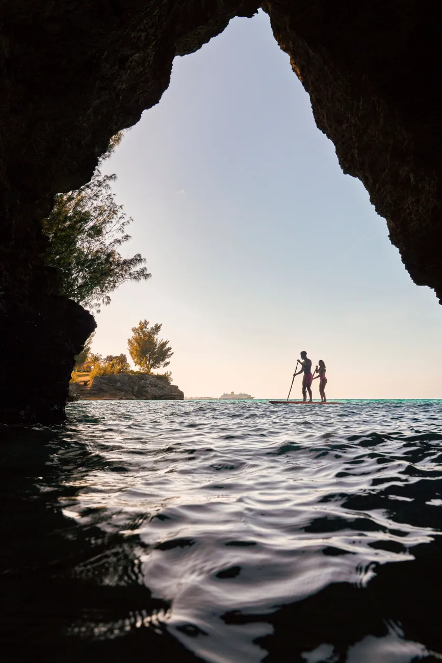 A couple is paddle boarding at Admiralty House