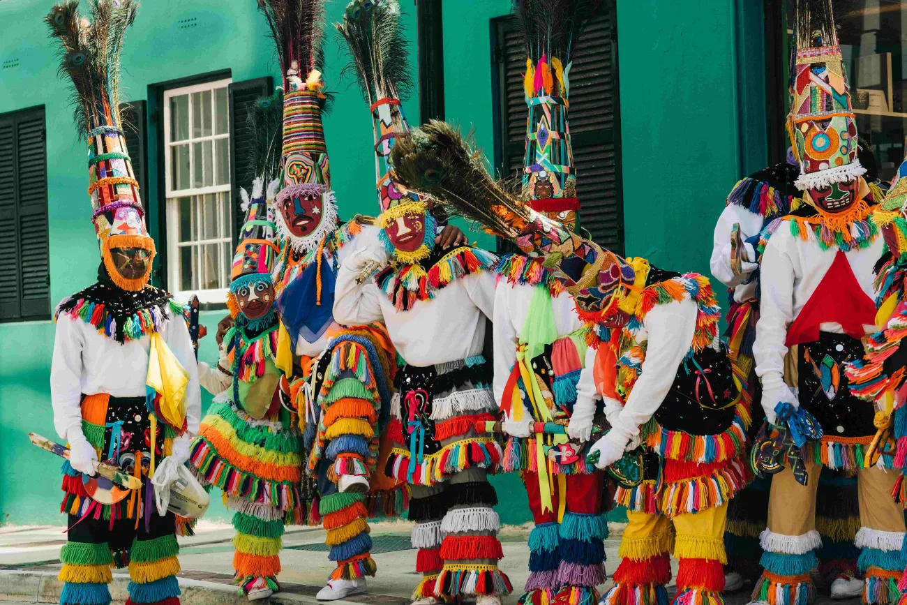 A group of colourful Bermuda gombeys are posing for the camera.