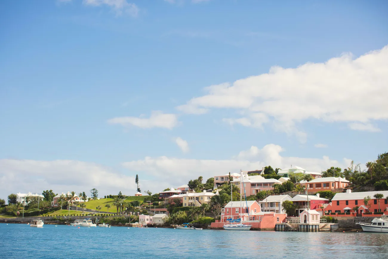 A wide shot of colourful houses from a boat. 