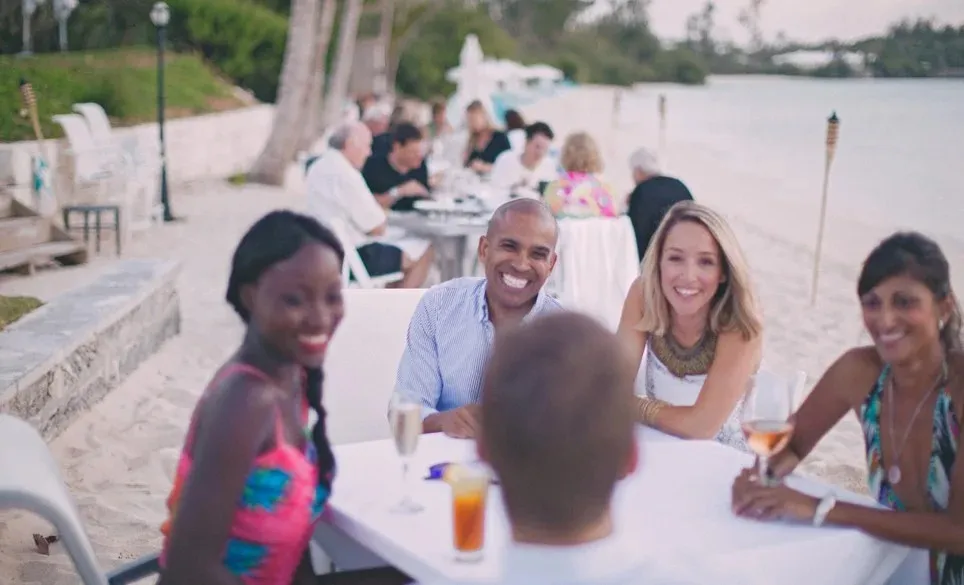 friends at the beach having drinks at a table