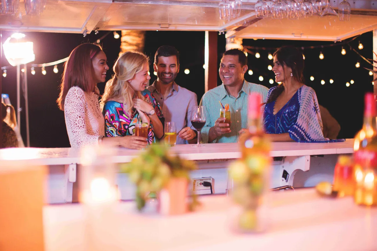 A group of friends are celebrating by the bar.