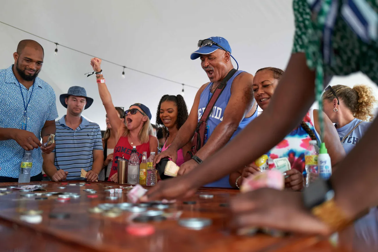 A group of people are playing crown & anchor.