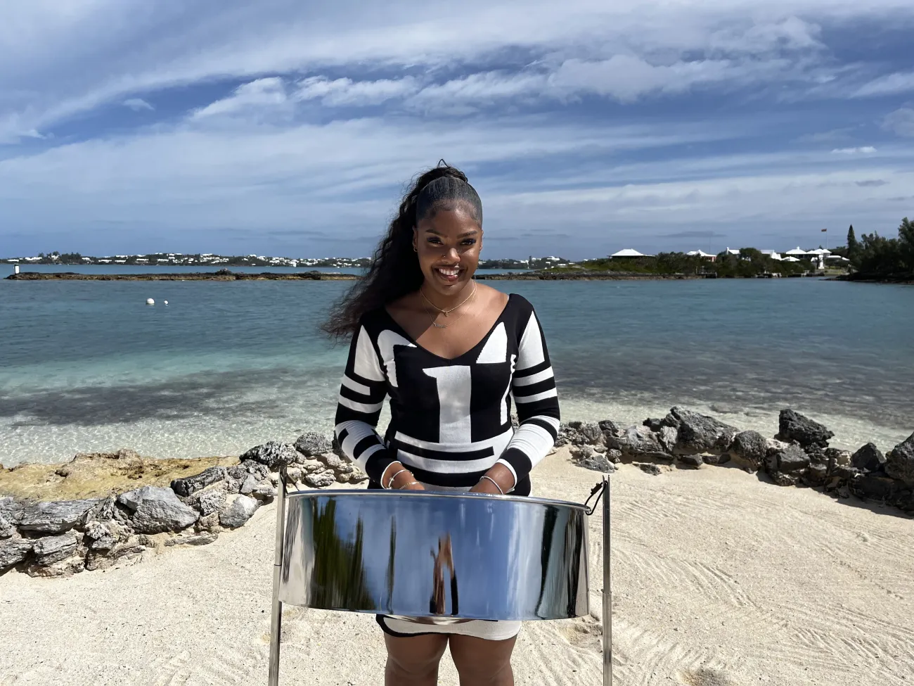 A woman is playing the steel pan.