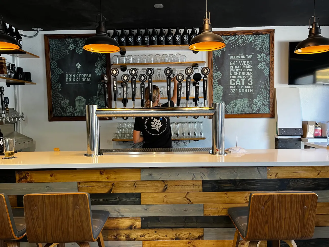 A woman is cleaning the beer taps in Bermuda Craft Brewery.
