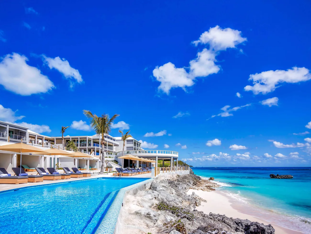 A crystal blue pool overlooking the deep ocean blue waters of Bermuda
