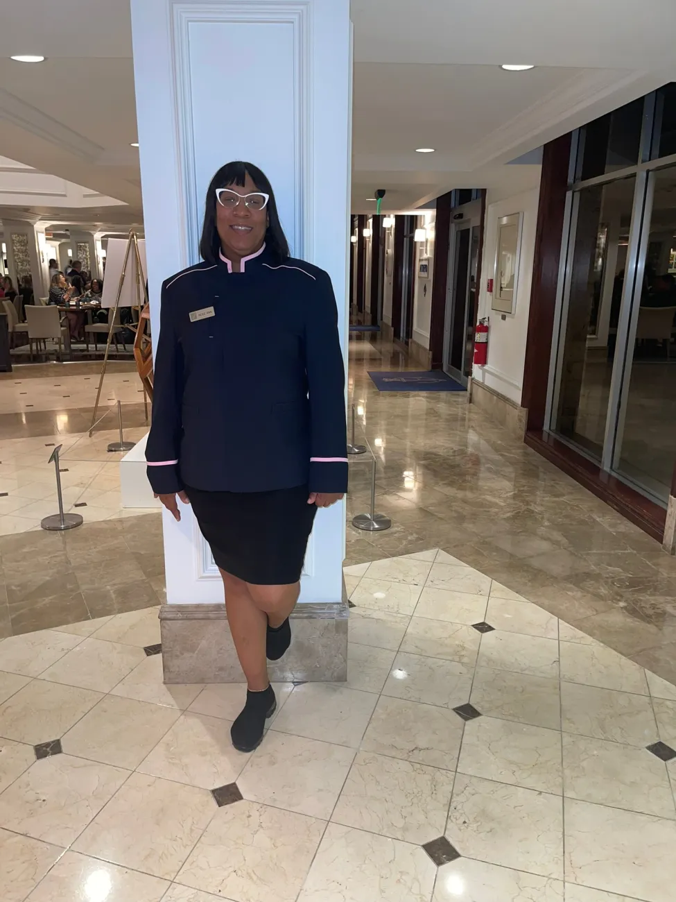 A bellwoman is smiling at the camera.