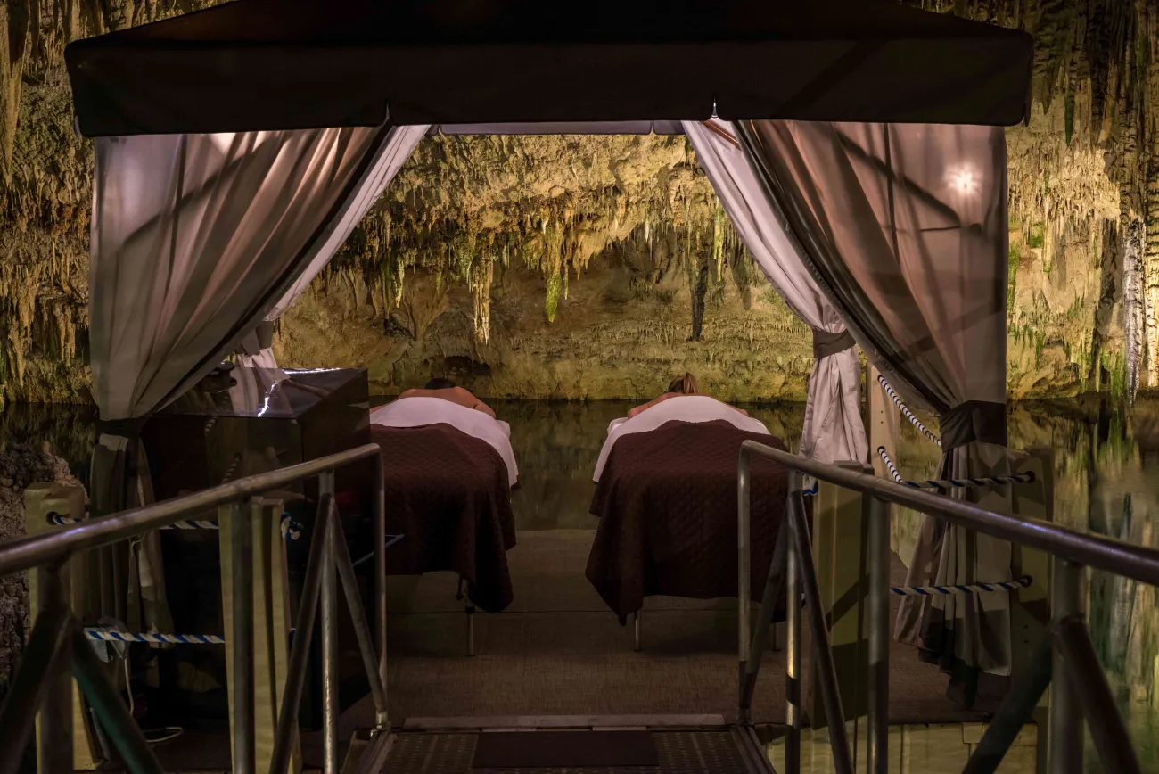 A couple is having a massage in a cave. 