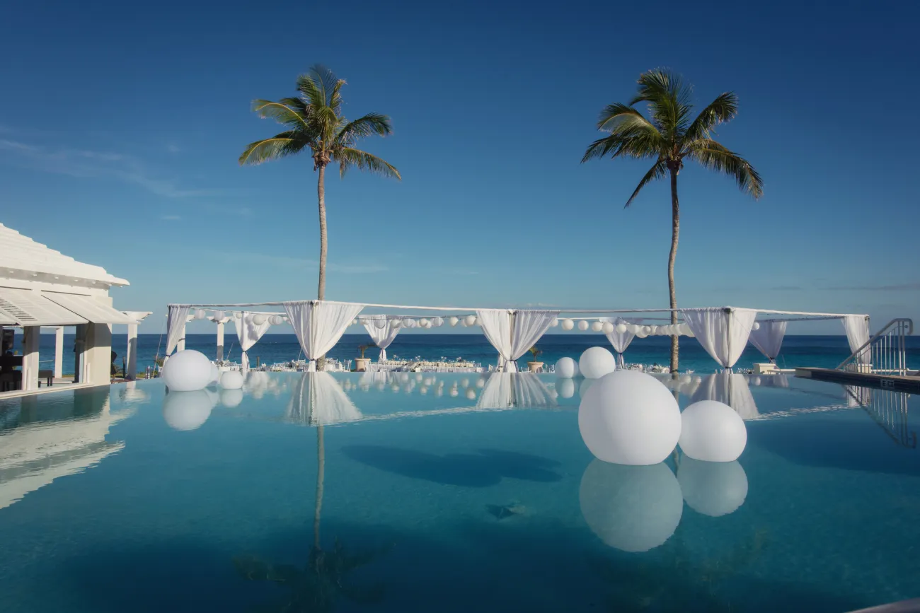 Balloons resting on an infinity pool