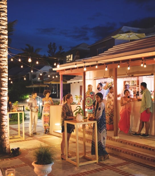 A group enjoying cocktails in Bermuda on an outdoor patio