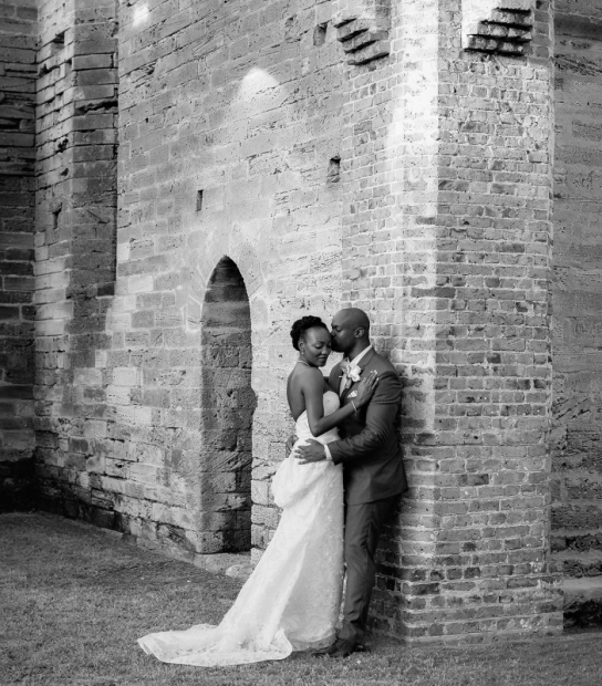 image of a couple leaning up against a wall