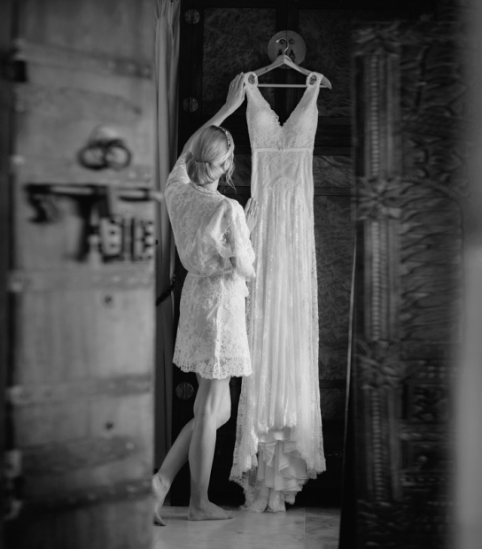 image of a woman looking at her wedding dress