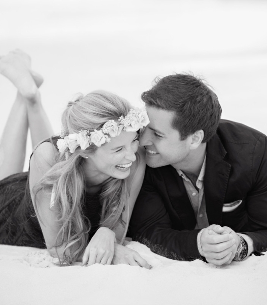 image of couple laughing on a beach