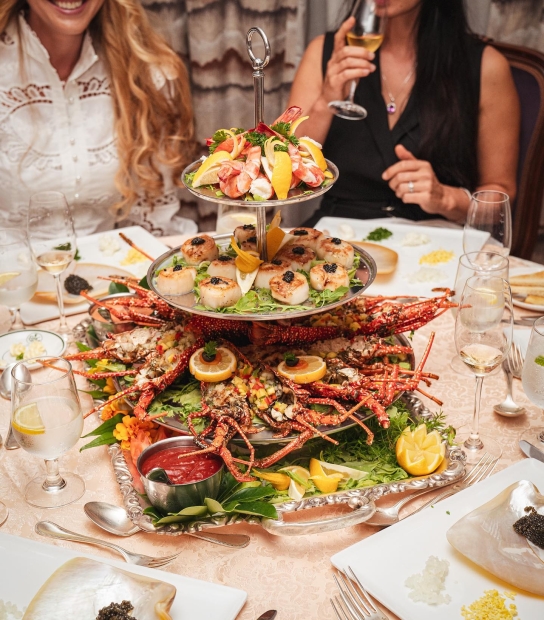 A table is filled with a lobster platter. 