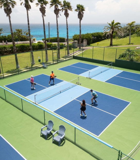 An aerial view of a group of people are playing pickleball.