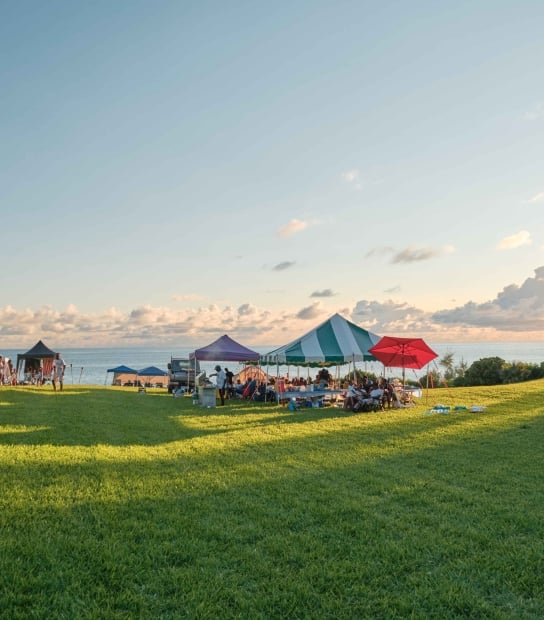 A family are camping by the waterside at Cup Match.
