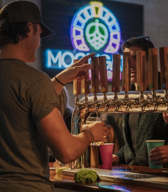 A close up of beer on a tap.