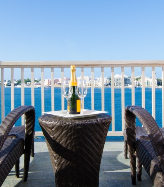 Newstead Belmont Hills Golf Resort & Spa – Champagne Site On A Table Between Two Chairs Overlooking Bermuda's Great Sound