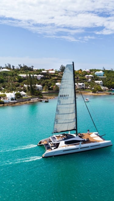 private sail boat gliding along the coastline