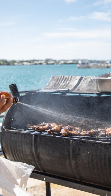 A man cooking on a barbecue in Bermuda