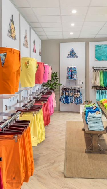 A store filled with brightly coloured Bermuda shorts. 
