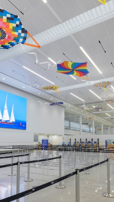 Interview of the LF Wade airport with colourful kites on the ceiling.