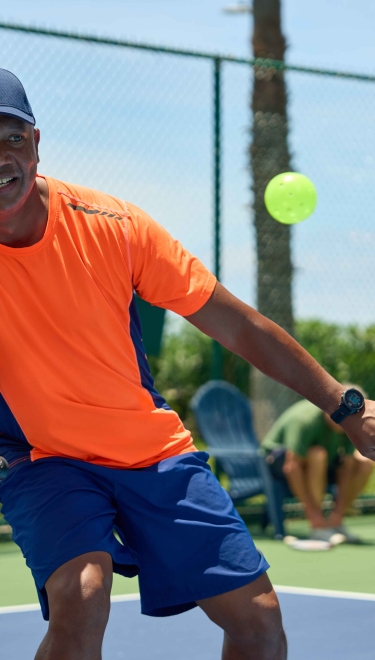 A gentleman playing pickleball.