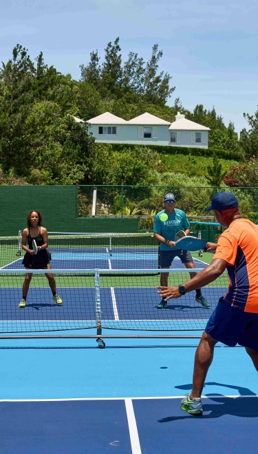 A group of people are playing pickleball