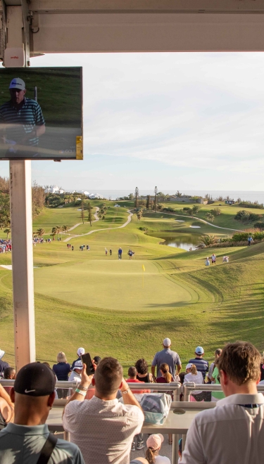 People watching the Butterfield Golf Championship on a calm day.