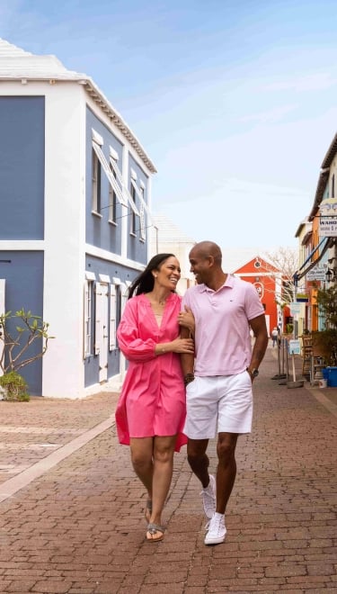 A couple is walking down waterstreet.