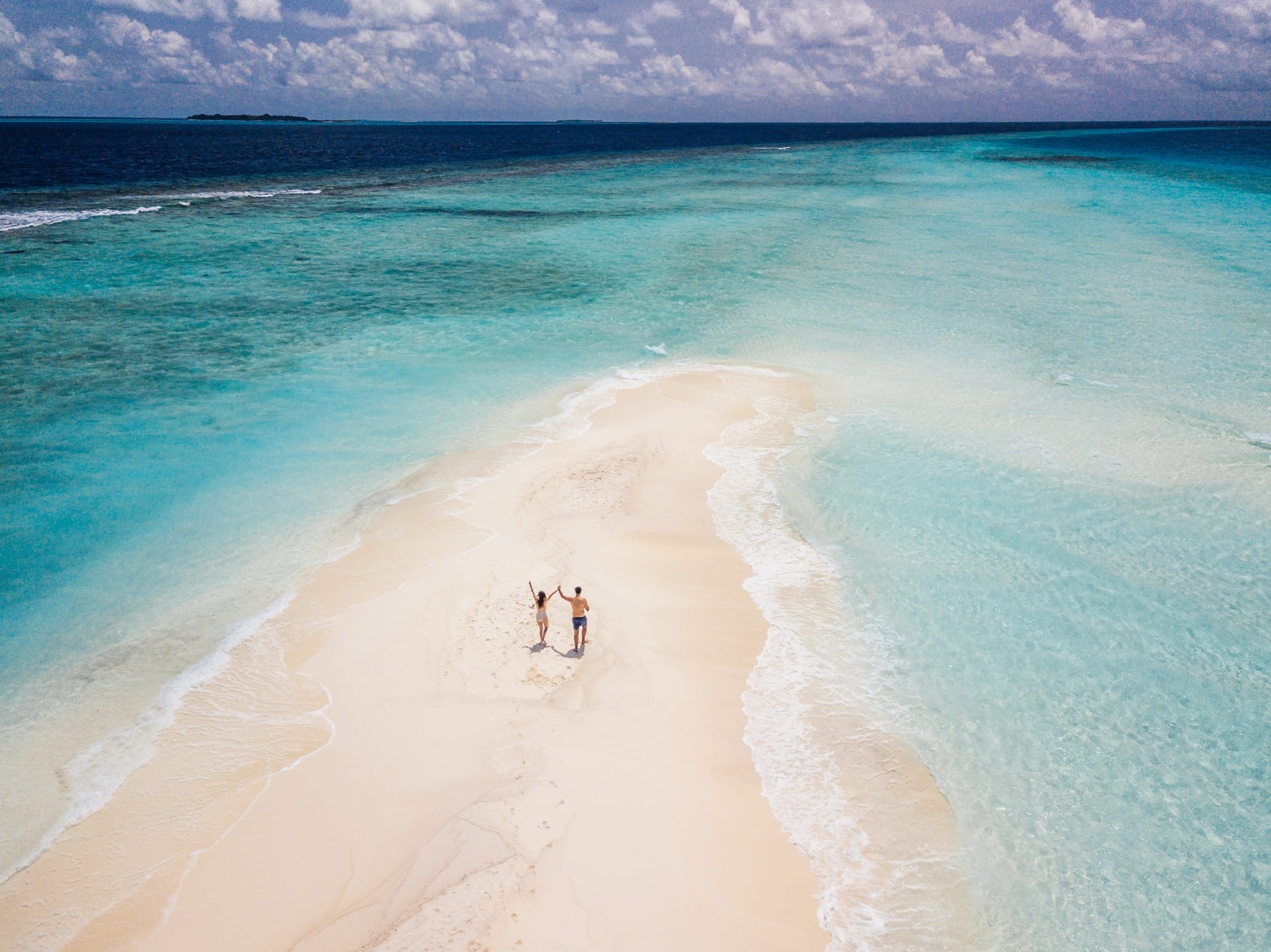 two people on a sand bar