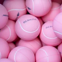 A collection of pink Bermuda-branded tennis balls