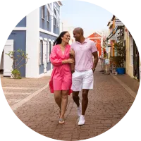 A couple walking down a colourful Bermuda street