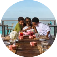 Friends sharing a meal at a waterside restaurant